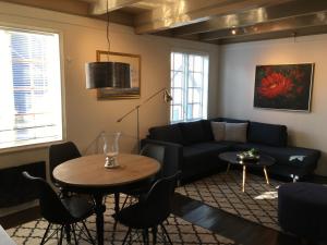 a living room with a couch and a table at Ellingsens Apartment Egersund in Egersund