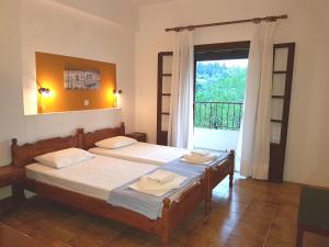 A bed or beds in a room at Alexandros Studios