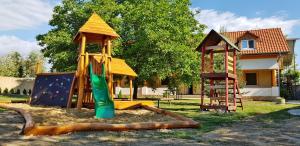 a playground with a slide and a play structure at Ubytovanie LISKA in Radava