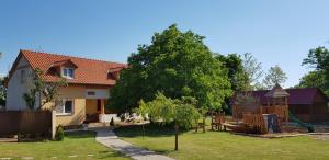a house with a yard with a playground at Ubytovanie LISKA in Radava