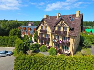 a large house with a car parked in front of it at Willa Hetman in Karwia