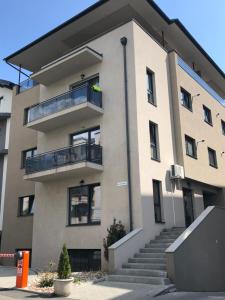 an apartment building with a balcony and stairs at Meteor apartment XXL in Cluj-Napoca