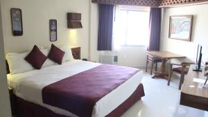 Postel nebo postele na pokoji v ubytování Hotel Plaza Kokai Cancún