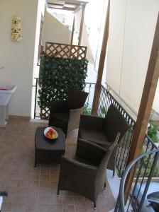 a balcony with chairs and a table and a plant at Annalisa Apartments 250 dal mare in San Vito lo Capo