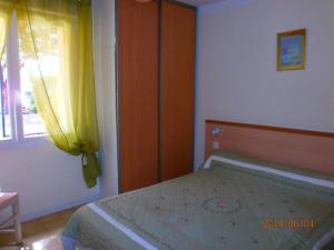 1 dormitorio con cama y ventana en Les gites de lozari, en Belgodère