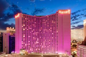 a large red and white building with colorful lights at Harrah's Las Vegas Hotel & Casino in Las Vegas