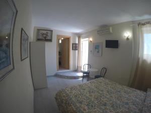 a bedroom with two beds and a room with a hallway at hotel la rondinella in Ischia