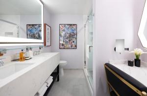 a bathroom with a sink, mirror, and toilet at Montrose at Beverly Hills in Los Angeles
