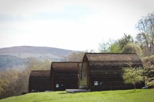a small wooden building on a grassy hill at Howe of Torbeg in Ballater