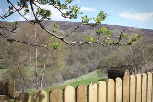 a wooden fence with a view of a train bridge at Howe of Torbeg in Ballater