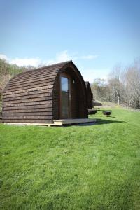 a large wooden cabin in a field of grass at Howe of Torbeg in Ballater