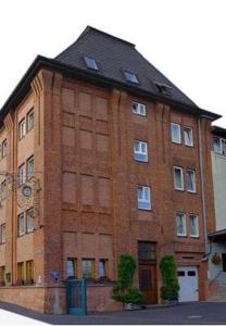 
a large brick building with a large window at Altes Sudhaus in Aschaffenburg
