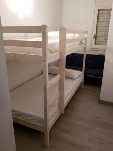 マルグラット・デ・マルにあるApartamento Malgrat de marの二段ベッド2組が備わる客室です。