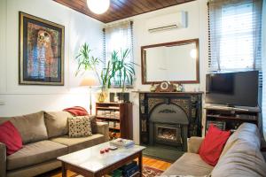 a living room with a couch and a fireplace at Sinnamons Cottage in Maldon