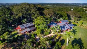 an aerial view of a house in the forest at The Figs Byron in Brunswick Heads