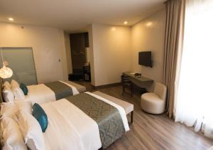 Llit o llits en una habitació de Goldberry Lite Hotel