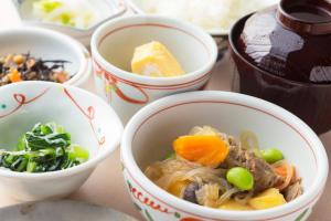 a group of bowls of food on a table at Hotel Lakeland Hikone in Hikone