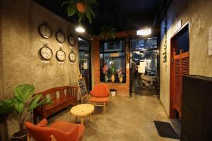 a room with two chairs and clocks on the wall at Cube Bed Station & Tours Sdn Bhd in Semporna