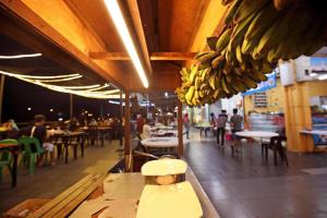 a bunch of bananas hanging from the ceiling of a restaurant at Cube Bed Station & Tours Sdn Bhd in Semporna