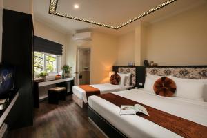Ένα ή περισσότερα κρεβάτια σε δωμάτιο στο Serenity Diamond Hotel