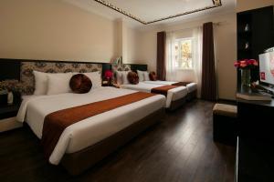 Ένα ή περισσότερα κρεβάτια σε δωμάτιο στο Serenity Diamond Hotel