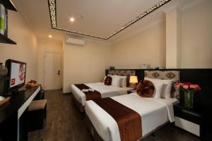 Ένα ή περισσότερα κρεβάτια σε δωμάτιο στο Serenity Diamond Hotel
