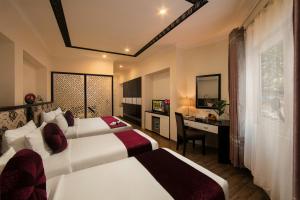 Ένα ή περισσότερα κρεβάτια σε δωμάτιο στο Serenity Diamond Hotel