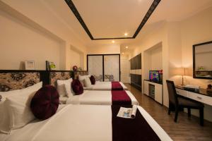 Ένα ή περισσότερα κρεβάτια σε δωμάτιο στο Serenity Diamond Hotel