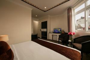 Ένα ή περισσότερα κρεβάτια σε δωμάτιο στο Serenity Diamond Hotel