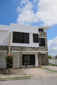 a white house with black windows at Tumon Bel-Air Serviced Residence in Tumon