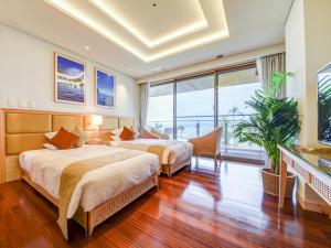 um quarto com 2 camas e uma grande janela em Ishigaki Resort Hotel em Ishigaki