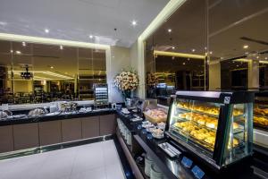 a bakery with a counter with a bunch of pastries at Mandarin Hotel Managed by Centre Point in Bangkok