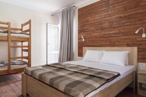 a bedroom with a bed and a wooden wall at Villa Solomare in Zatoka