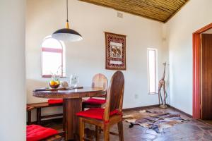 a dining room with a table and chairs at Krumhuk Guestfarm in Willemshof