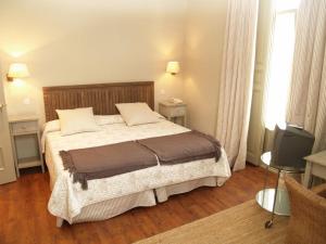 Ένα ή περισσότερα κρεβάτια σε δωμάτιο στο Hotel Roma