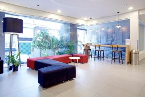 a living room with a couch and a table at Red Planet Makati Avenue Manila in Manila