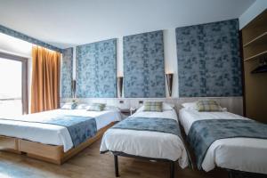 Postel nebo postele na pokoji v ubytování Hotel Comtes De Challant Albergo Etico Valle d'Aosta