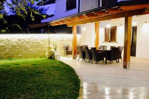 a dining table and chairs on a patio at Villa Sabaudia in Sabaudia