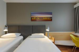 Postel nebo postele na pokoji v ubytování ibis Hotel Würzburg City