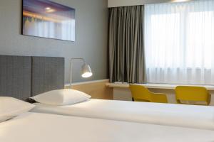 Postel nebo postele na pokoji v ubytování ibis Hotel Würzburg City