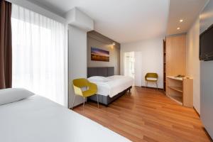 Postel nebo postele na pokoji v ubytování ibis Hotel Würzburg City