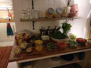 a counter with many different types of vegetables on it at Hotel Teltta in Orimattila