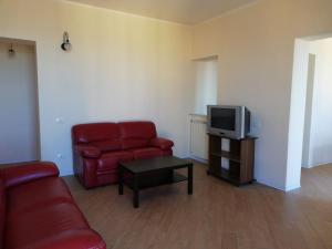 a living room with a red couch and a tv at Backpackers in Agrigento