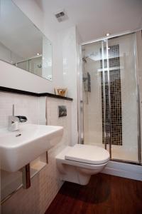 a bathroom with a sink and a toilet and a shower at The Spires Serviced Apartments Glasgow in Glasgow