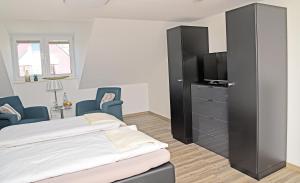 a bedroom with a bed and a flat screen tv at Weindepot Xanten in Xanten