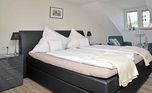 a bedroom with a large bed with a black frame at Weindepot Xanten in Xanten