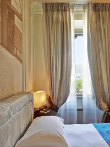 Кровать или кровати в номере Albergo Terminus