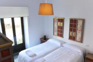 Ein Bett oder Betten in einem Zimmer der Unterkunft Casa del Portillo-Centro Histórico