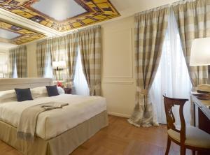 Кровать или кровати в номере Albergo Terminus
