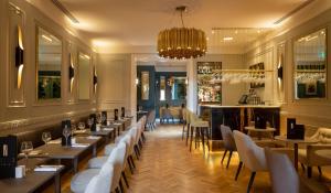a restaurant with tables and chairs and a bar at Hotel 7, Dublin City Centre in Dublin